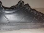 Black sneakers with visible stitching