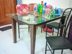 ডাইনিং টেবিল এবং চারটি লোহার চেয়ার
