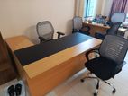 Two identical bespoke office desks with a set of chairs