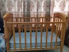 Wooden baby cot with mattress